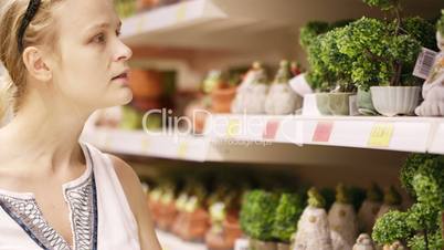 attractive woman choosing potted plants