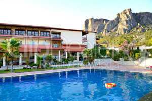swimming pool at the luxury hotel and meteora mountains at backg