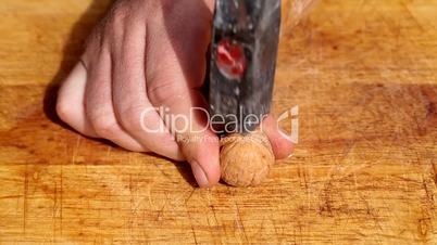 Breaking walnut with hammer