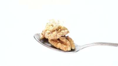 Honey and nuts on spoon close up