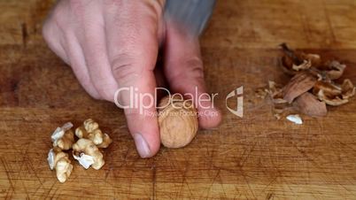 Breaking walnut with hammer