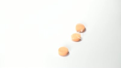 Orange pills falling