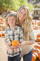attractive mother and son portrait at the pumpkin patch.