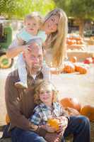 attractive family portrait at the pumpkin patch.