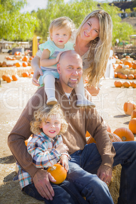 attractive family portrait at the pumpkin patch.