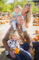 attractive family portrait at the pumpkin patch.