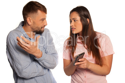 young couple discussing an sms message