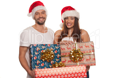 happy couple carrying christmas gifts