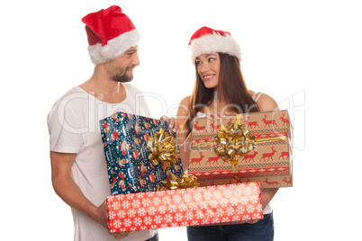 smiling young couple with large xmas gifts