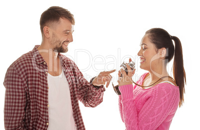 man pointing to a camera in his wifes hands