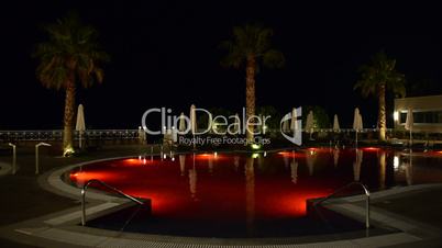 Swimming pool at the luxury hotel with changing colors, Halkidiki, Greece