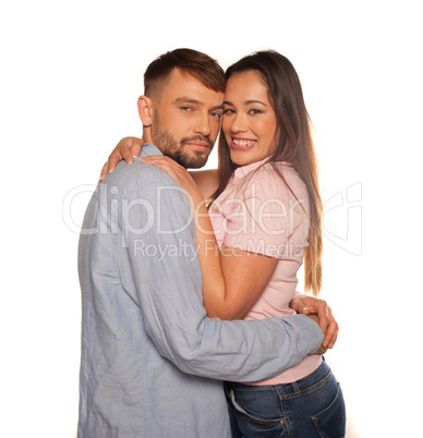 young romantic couple embraced looking at camera