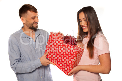 young man offering a gift to his girlfriend