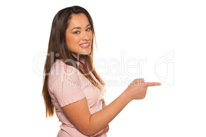 profile portrait of a happy young woman pointing