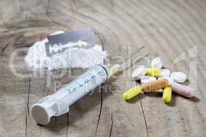 heroin syringe and pills