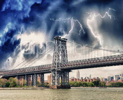 Storm above Manhattan Bridge structure and East River - New York