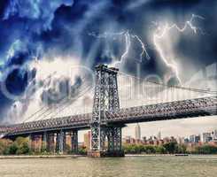 Storm above Manhattan Bridge structure and East River - New York