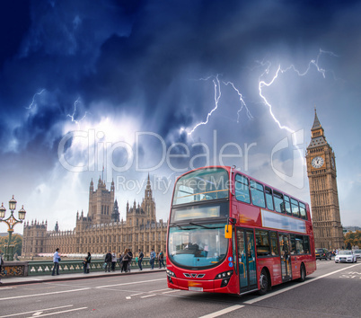 Double decker bus crossing Westminster Bridge with stormy weathe