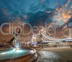 London. Girl with Dolphin Fountain and gorgeous view of Tower Br