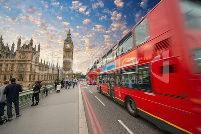 Iconic red bus passing over Westminster Bridge in London