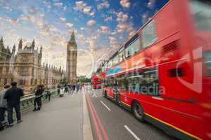 Iconic red bus passing over Westminster Bridge in London