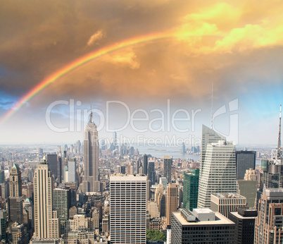 Rainbow over Manhattan sky, beautiful skyline of New York at sun
