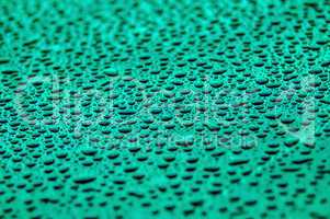 cyan drops on water-repellent surface