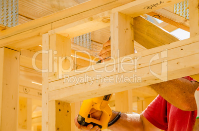 building contractor worker using a reciprocating saw to cut