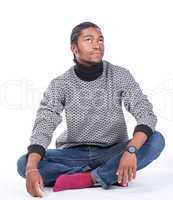 young african-american male sitting on the ground
