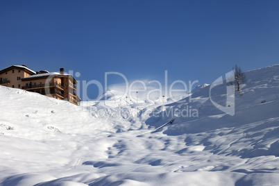 off-piste slope and hotel in winter mountains