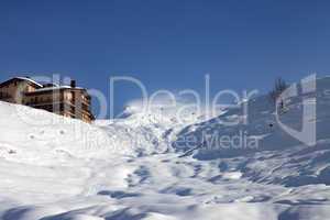 off-piste slope and hotel in winter mountains