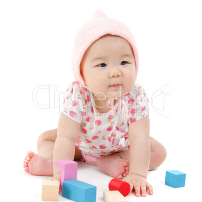 asian baby girl playing wood blocks