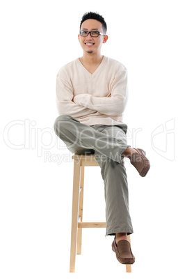 asian male sitting on a chair