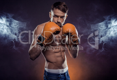 Young athletic boxer exhibiting