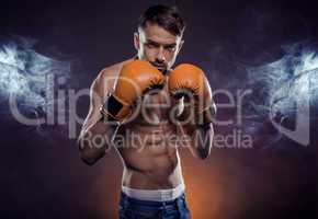 Young athletic boxer exhibiting