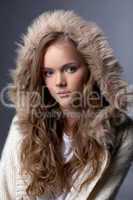 Image of enchanting young girl posing in fur hood