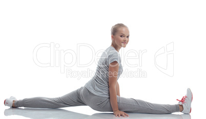 Smiling cute teenage girl doing stretching