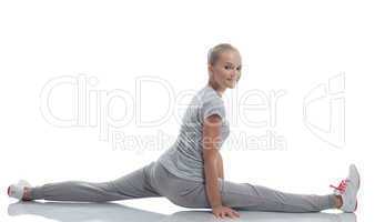 Smiling cute teenage girl doing stretching