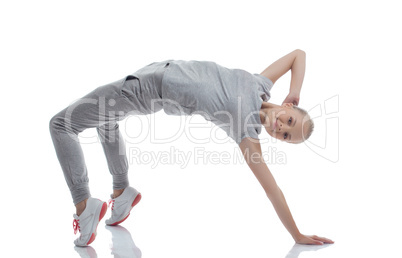 Smiling athletic girl doing gymnastic bridge