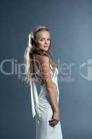 Beautiful slim model posing in long white dress