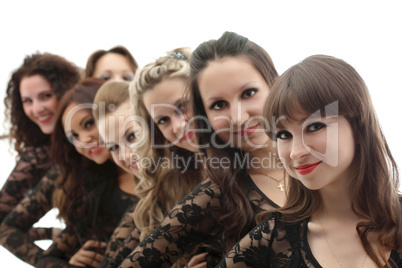 Group of young smiling girls posing in studio