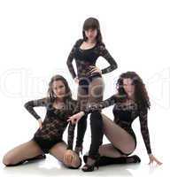 Alluring sexy dancers in black go-go costumes