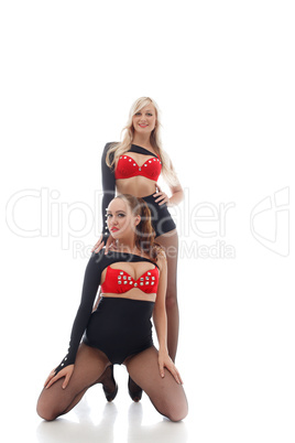 Smiling attractive go-go dancers isolated on white