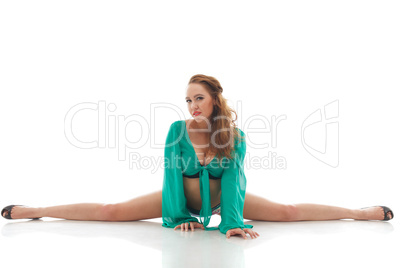 Attractive slim dancer sitting on split