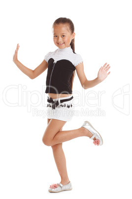 Cheerful little girl posing in fashionable clothes