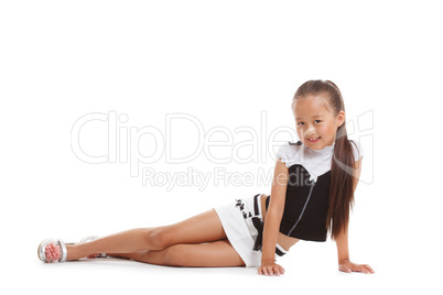 Image of smiling little brunette posing in studio