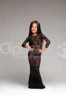 Smiling little girl posing in black lace dress