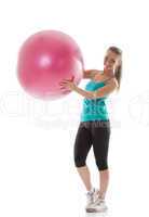 Funny girl posing in sportswear with pink ball