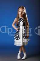 Image of cute girl posing in blue polka dot dress