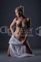 Sensual naked woman posing with white cloth
